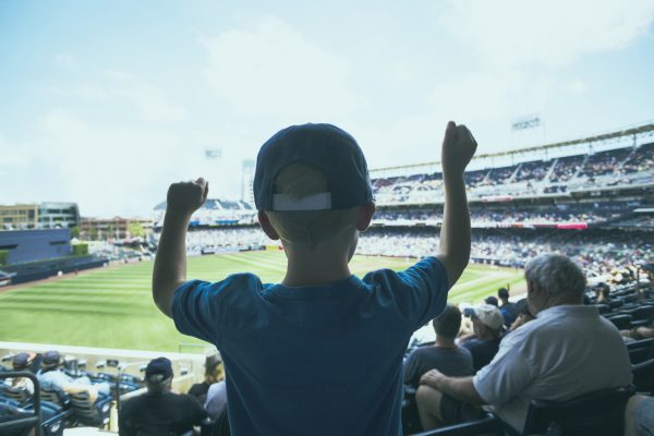 街コンレポート＿男の子がスタジアムで野球観戦をしてガッツポーズしています