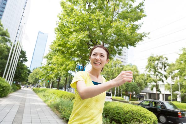 街コンレポート＿女性が微笑みながらウォーキングをしています