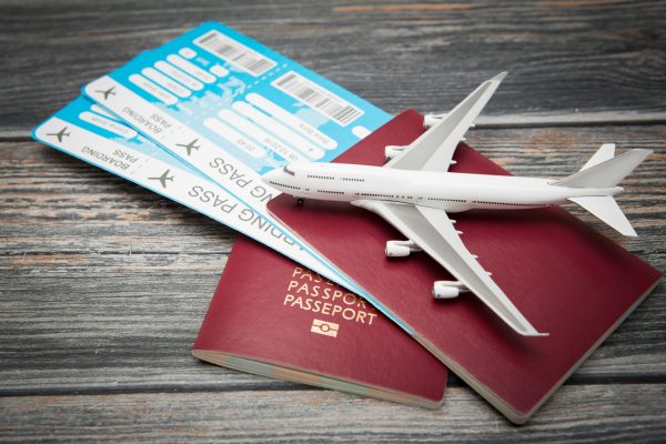 街コンレポート＿飛行機のチケットとパスポートの上に飛行機の模型